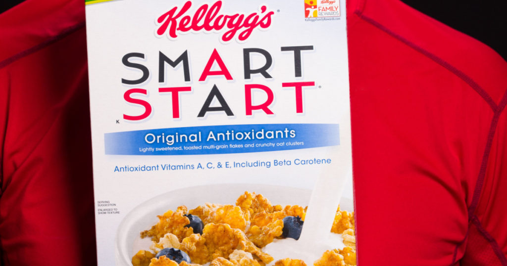 MIAMI, FLORIDA USA -?? FEBRUARY 4, 2014: Photo of a handsome middle age man holding a box of Kellogg's Smart Start breakfast cereal.