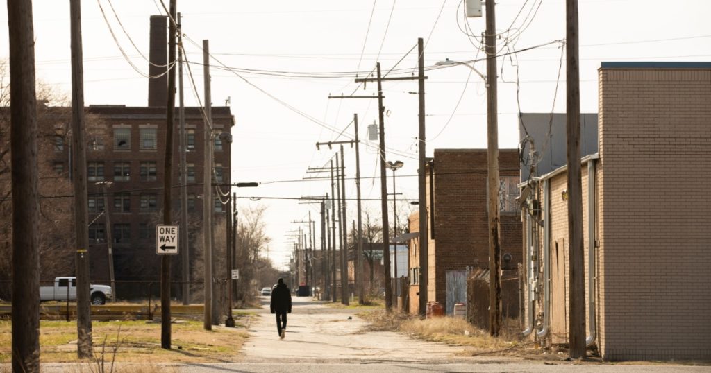 Gary, Indiana, USA - March 28, 2022: Afternoon light shines on crumbling houses and a vacant lot in downtown Gary.