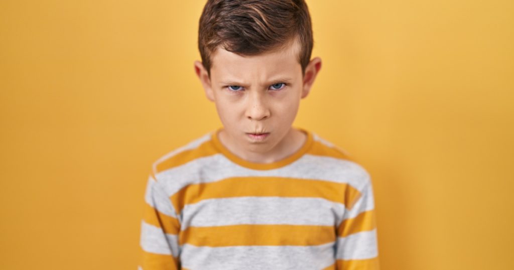 Young caucasian kid standing over yellow background skeptic and nervous, frowning upset because of problem. negative person.