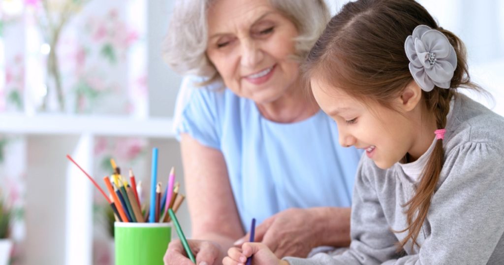 Grandmother with granddaughter drawing together