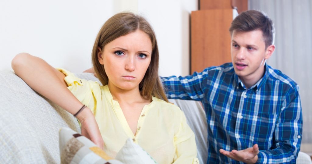 unhappy person criticizing young spouse in living room