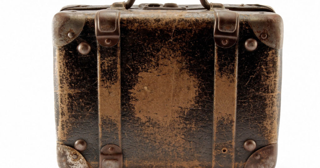 Old brown suitcase for travel white background.