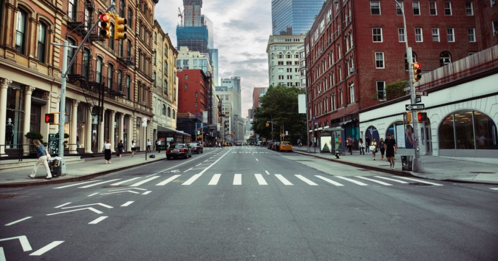 New York City street road in Manhattan at summer time. Urban big city life concept background.