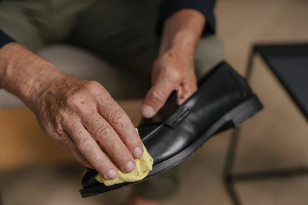 A Person Polishing a Shoe with Vaseline
