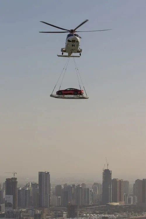 Witness helicopters soaring above skyscrapers, tasked with transporting luxury vehicles across the city—a sight unique to Dubai's skyline.