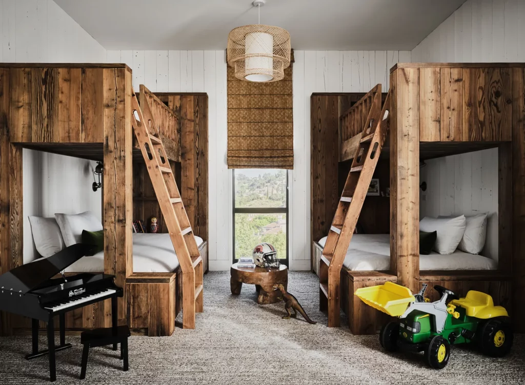 Two bunk beds made of wood, surrounded by kids' toys.