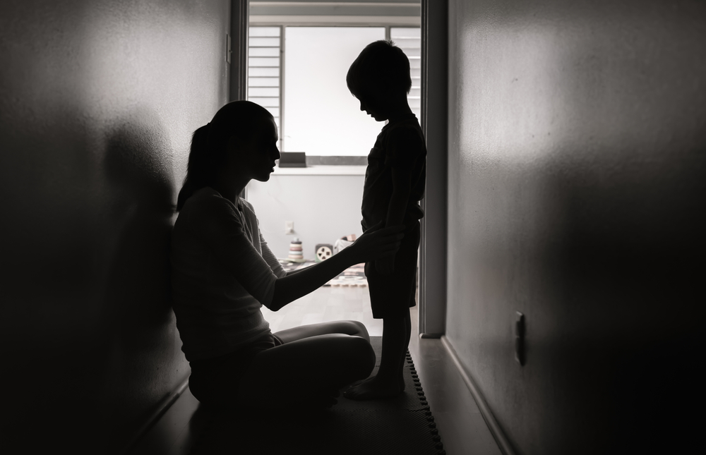 Mother talking to her child at home. Correcting, and disciplining children concept.
