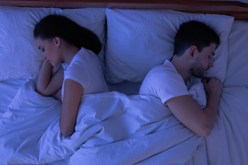 Sexless Relationship. Couple Sleeping Lying Back-To-Back Having No Sexual Life In Bed At Home At Night. Top-View, Low Light