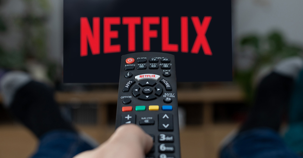 Remote pointing at television with Netflix displayed on it