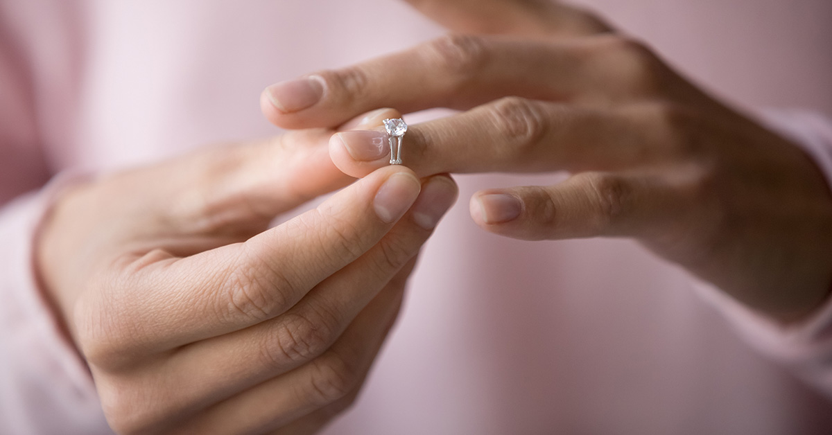 woman taking off wedding ring. Divorce concept