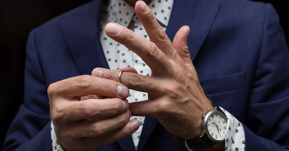 man taking off his wedding ring. Cheating concept