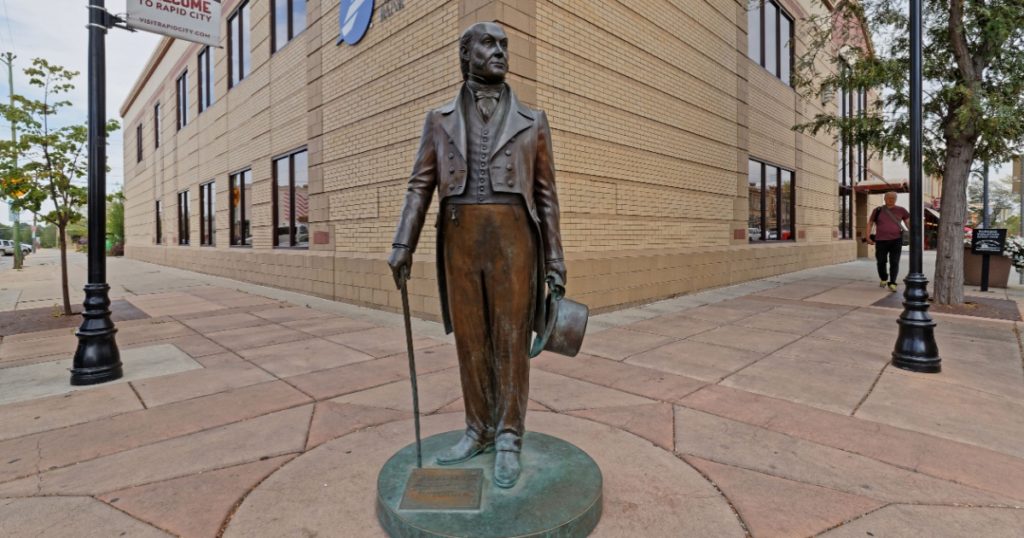 RAPID CITY, SOUTH DAKOTA, September 11, 2018 : John Quincy Adams statue. The City of Presidents is a series of life-size bronze statues of past presidents along Rapid City streets.
