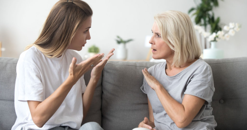 Angry young woman has disagreement with annoyed old mother in law, grown daughter arguing fighting quarreling with senior elderly mom, different age generations bad relations family conflict