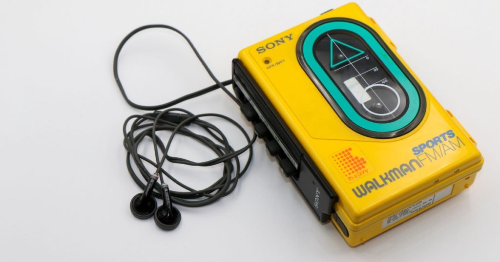 Dublin, Ireland - May 2022: Sony Sports Walkman radio cassette player. Retro vintage portable audio music device 1980s. Earphones or in-ear headphones attached.