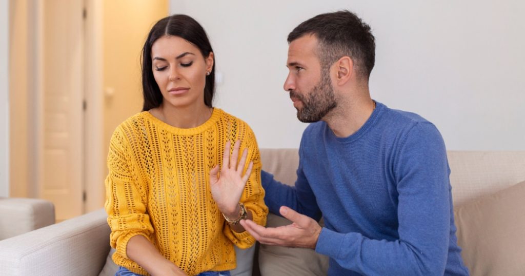 Stressed young man saying sorry after quarrel to frustrated wife. Depressed offended woman ignoring apologizing husband . Family relations problems, divorce, break up concept.