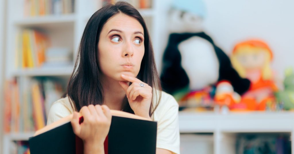 Puzzled Mom Reading a Book on Parenting. Clueless woman feeling confused trying to find some answers