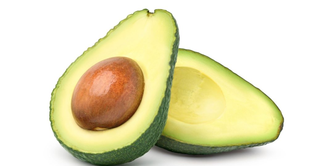 Avocado cut in half isolated on white background. Clipping path.
