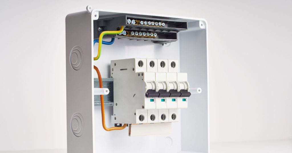 Automatic fuses and wires in fusebox. Electricity distribution box inside.