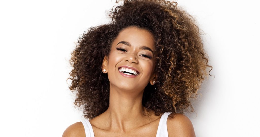 Beautiful african american girl with an afro hairstyle smiling