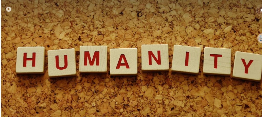 Tiles spell out humanity.