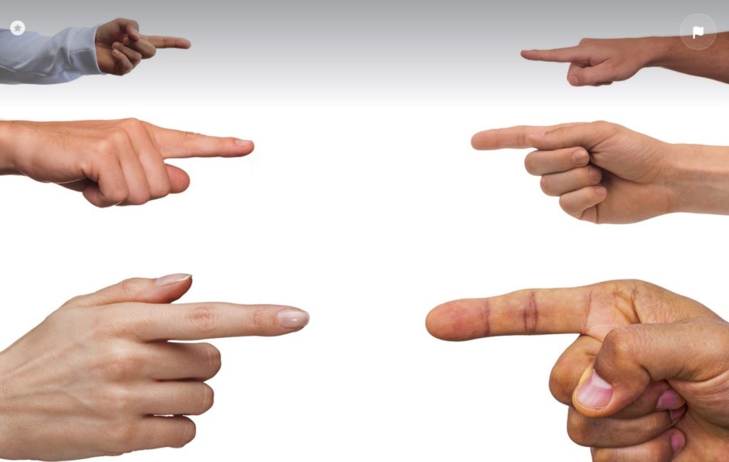 Fingers pointing at each other. White background.