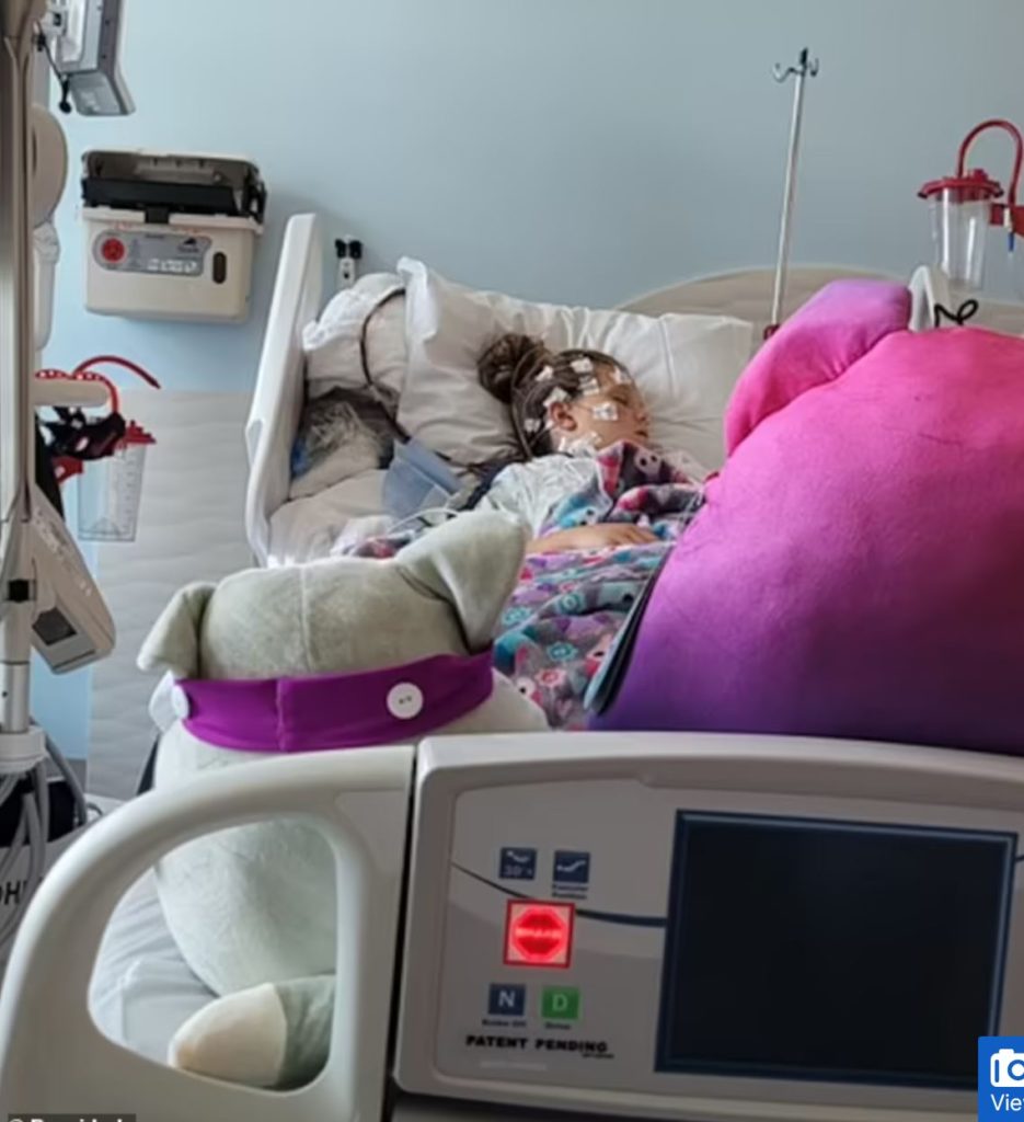 Girl lying in hospital bed