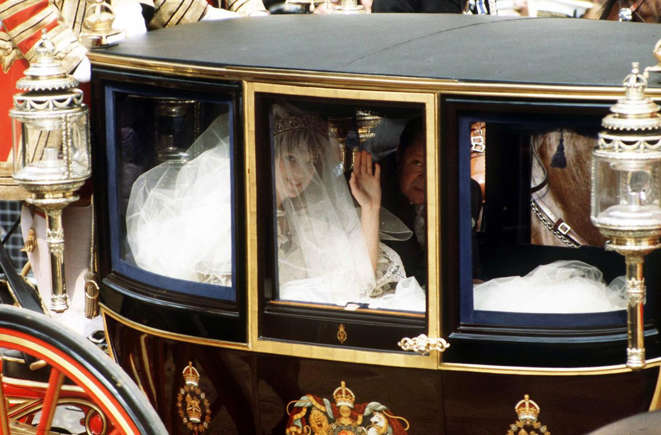 Princess Diana waves from her carriage in her wedding dress