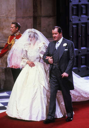 Princess Diana walking down the aisle alongside her father.