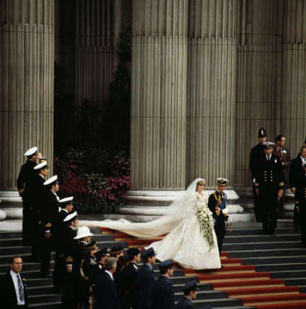 The royal couple walking down the stairs hand-in-hand