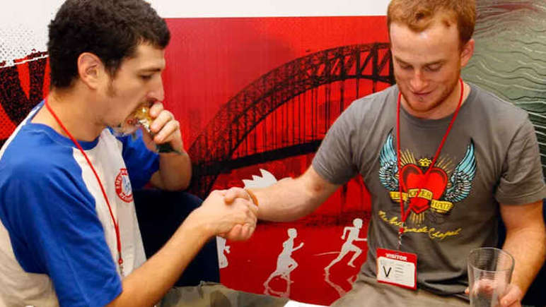 Jack Tsonis and Lindsay Morrison attempting the world's longest handshake.