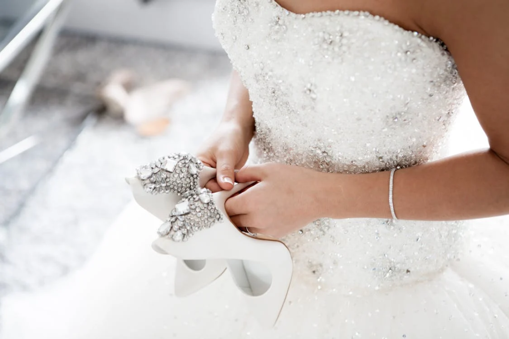 Bride holding shoes