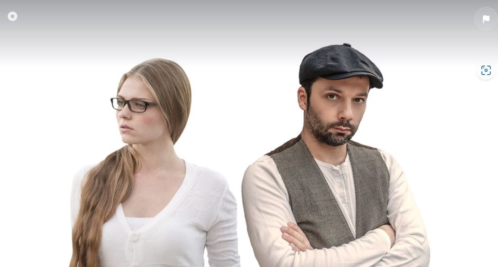 Man and woman standing looking away from each other. White background.