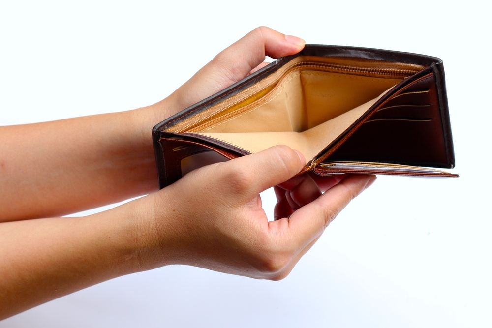 Hands holding empty brown wallet