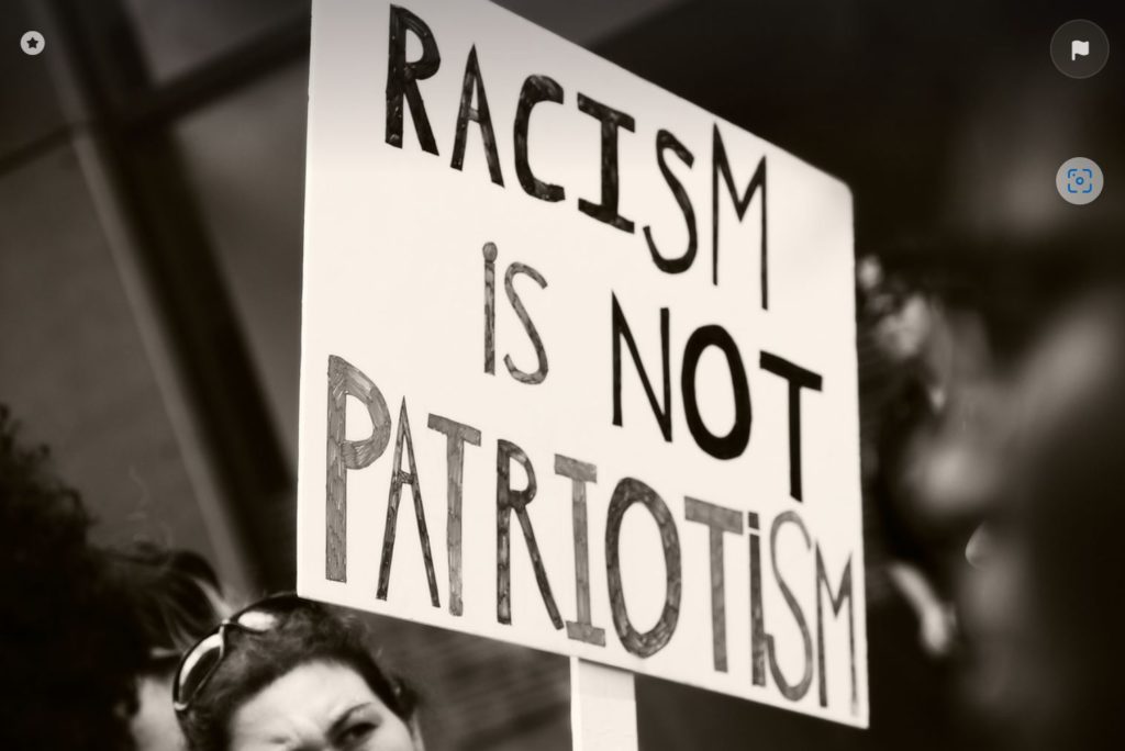 Protest sign fighting racism.