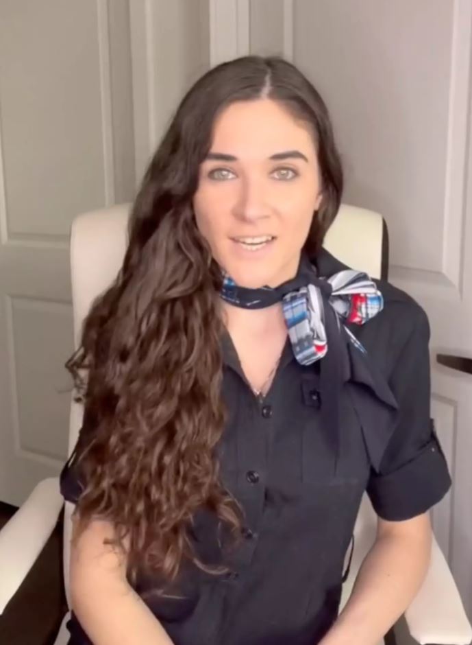 TikToker sits in chair and reveals how to get a flight upgrade to her followers. 
