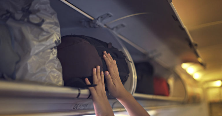  Flight Attendant Reveals Why They Won’t Put Your Bag in Overhead Compartment for You - Featured image