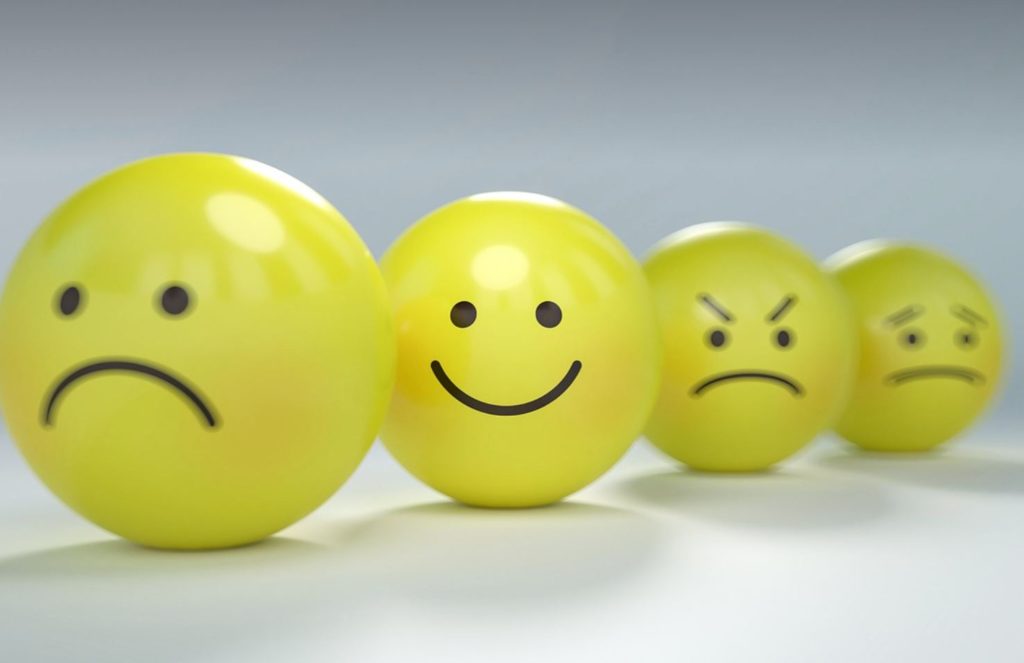 4 yellow smiley balls with faces expressing various emotions. All white background. 