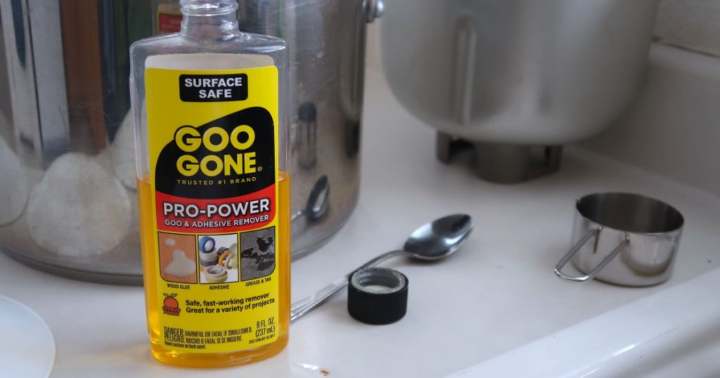 Longmont, CO USA - March 14, 2021: Bottle of Goo Gone brand adhesive remover sitting on a counter with stainless steel kitchen items