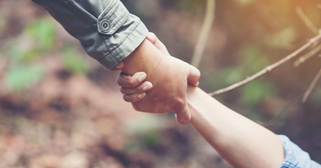 Friends holding hands pulled Help. Help each other or Strong hold.
