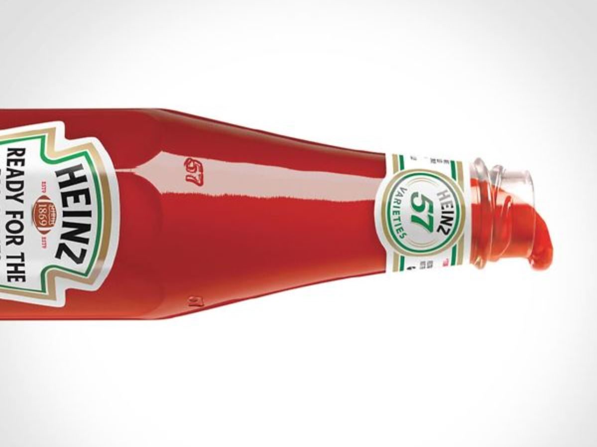 A ketchup bottle on its side. White background. 