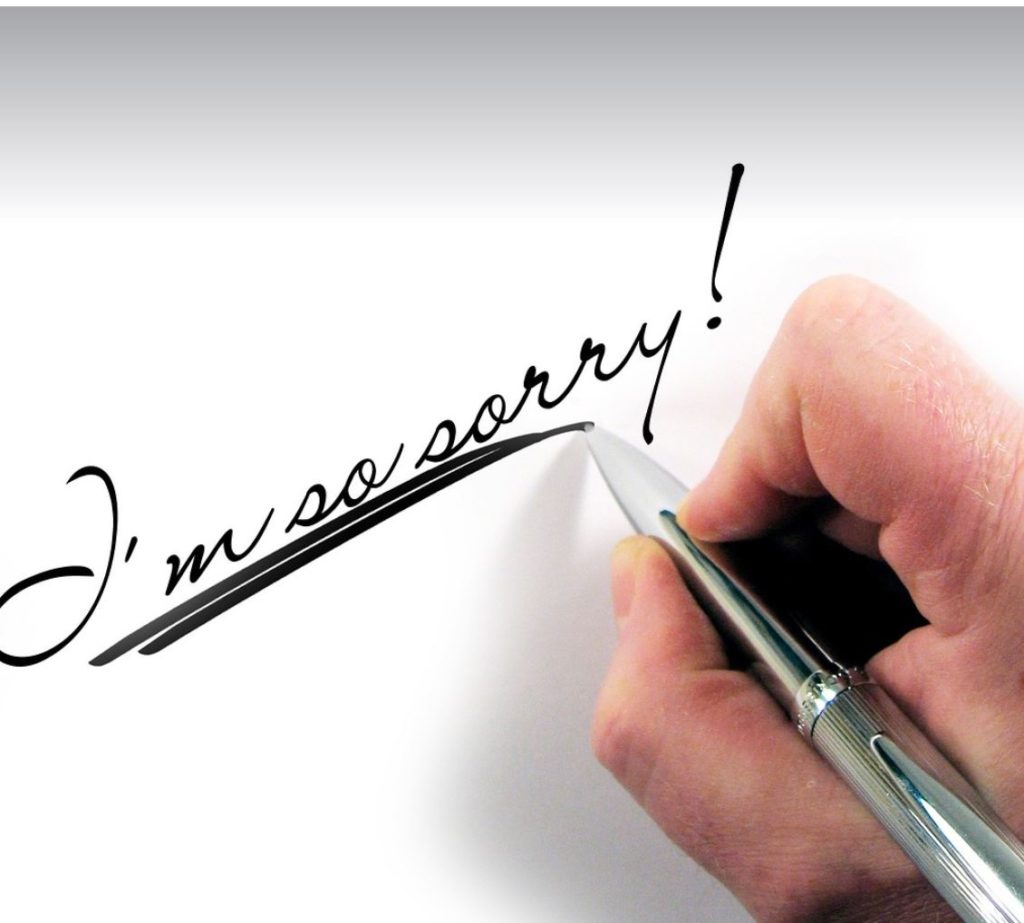 A hand-written apology. White background. 
