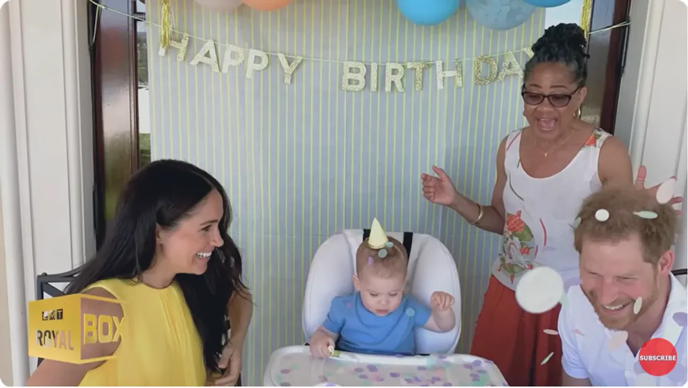 Meghan, Duchess of Sussex, Doria Ragland, and Prince Harry, Duke of Sussex celebrate Archie Harrison Mountbatten-Windsor's birthday at home from a YouTube video dated December 15, 2022
