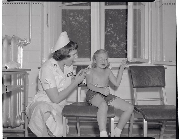 Nurse giving a polio vaccine