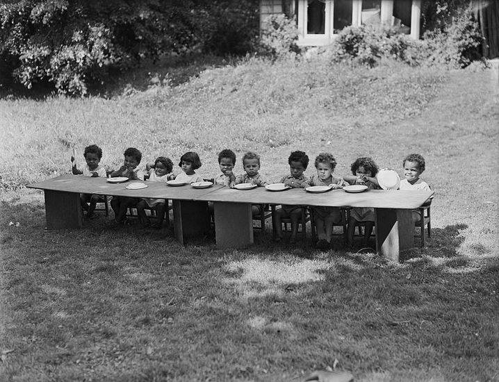 Children lined up with empty plates