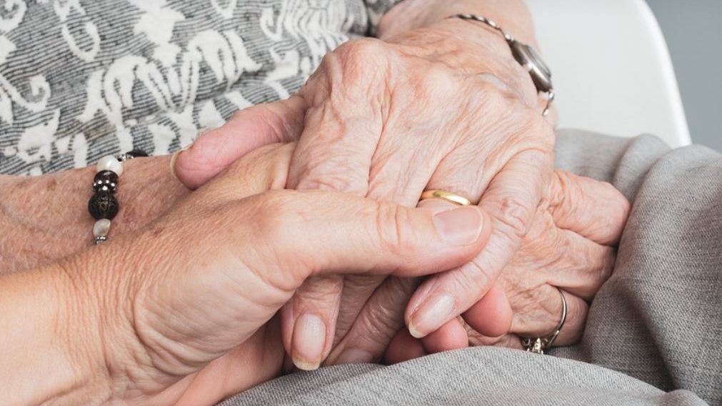 Older women holding hands. 