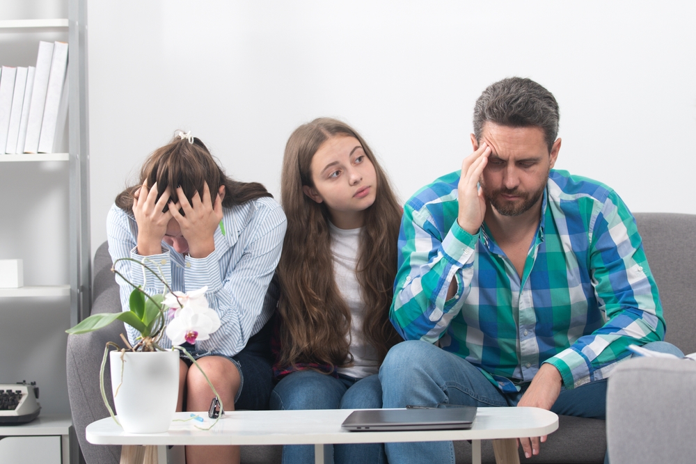 Trouble couple with unhappy child teenager discussing problems in worry family. Conflicts marital sad couple with kids crisis.