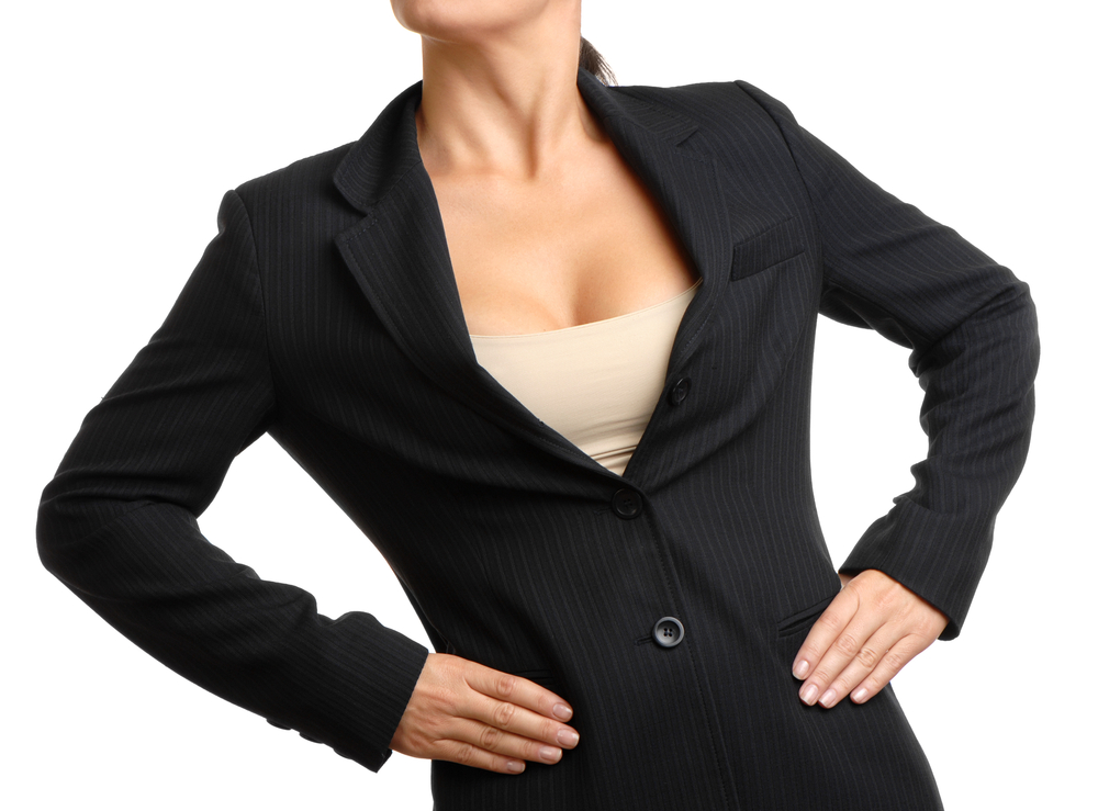 Businesswoman With Hands on Hips on White