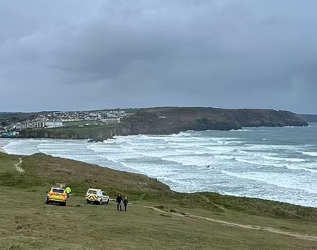 Two rescue vehicles on the beach. Ocean in the background.