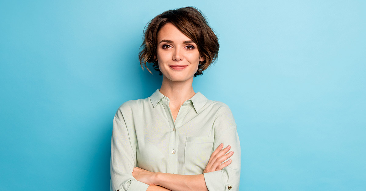 woman with arms crossed. Blue background