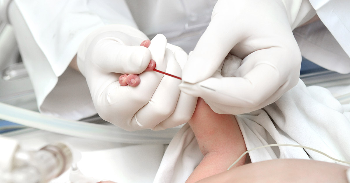 making medicine blood sampling from finger of newborn child in infant incubator